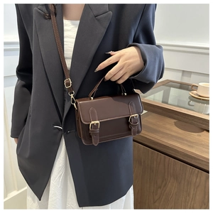 Classic dark brown leather messenger bag shown with vintage metal double buckle detail