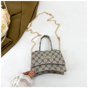 Detail of vintage pattern handbag with hourglass curved bottom and gold chain strap