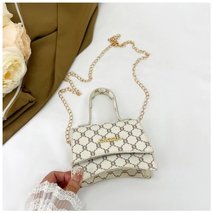 Close-up of beige chain bag with vintage geometric patterns and gold metal logo
