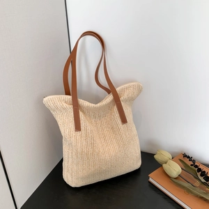 Chic beige woven tote bag with brown leather handles and zipper closure for daily commute