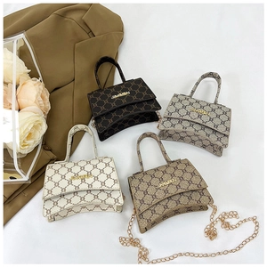 Flat lay of vintage monogram mini bags in cream, brown, grey and khaki with gold chain