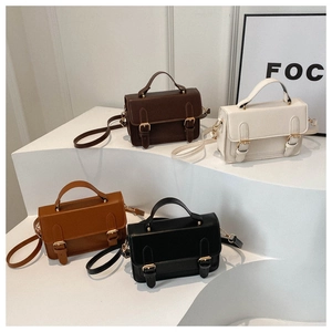 Detailed close-up of retro PU leather square handbags in four colors with gold buckles