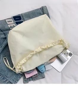Detail view of large nylon cloud bag showing spacious interior with personal essentials