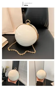 Detail of white marble-pattern sphere bag with gold metal frame and ring clasp