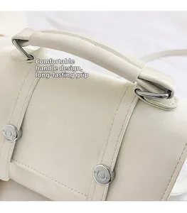 Detail of comfortable cream white leather handle and durable metal buckle on backpack