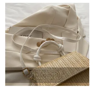 Detailed woven straw texture with white leather strap and adjustable golden buckle