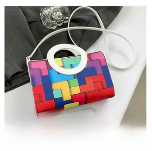 Macro shot of geometric color-block bag with fine leather texture and white round handle