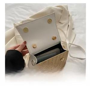 Detail view of woven crossbody bag interior showing space for phone and wallet