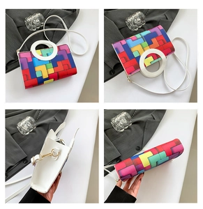 Detail view of colorful geometric block pattern handbag with round handles and strap