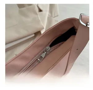 Detail of pink tote bag showing the smooth silver metal zipper and fine leather texture