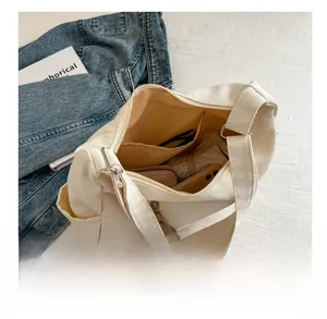Detail view of large capacity canvas tote interior with daily essentials and pockets