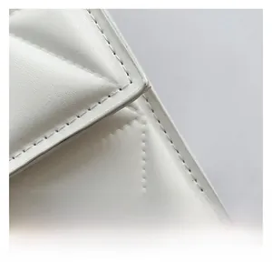 Detail shot of premium white quilted leather surface with elegant diamond stitching