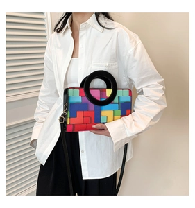 On-model view of colorful checkered crossbody bag with circular handle and thin strap