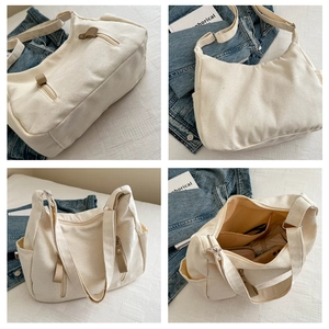 Macro details of off-white canvas tote bag showing interior compartments and zippers