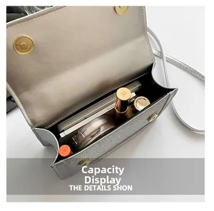 Detail view of silver sequin crossbody bag interior showing space for phone and makeup