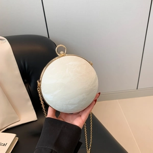Chic cream spherical evening clutch bag with gold ring handle and metal chain strap