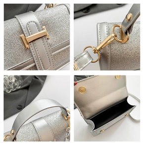 Detail of silver sequin handbag showing gold metal buckle, D-rings and magnetic closure