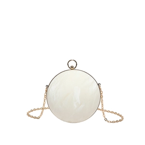 Spherical evening clutch bag with marble texture, gold metal frame and chain strap