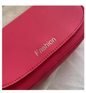 Macro shot of hot pink leather texture and silver Fashion engraving on a saddle bag