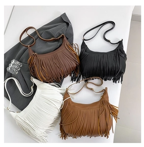 Flat lay of bohemian hobo bags with tassels in black, white, brown, and caramel colors