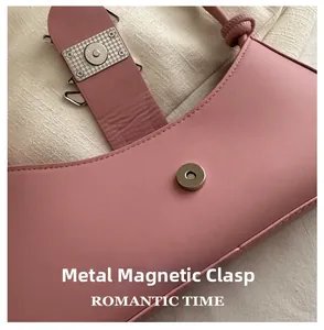 Detail of pink leather shoulder bag with metallic magnetic clasp and ROMANTIC TIME logo