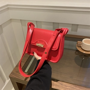 Chic red rectangular shoulder bag with elegant gold cylindrical rotating metal clasp