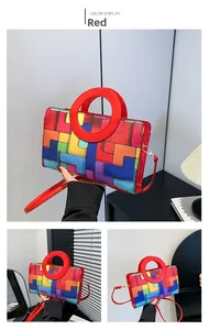 Detail of red crossbody bag featuring colorful geometric patterns and round handle