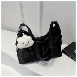 Minimalist black velvet tote bag with adjustable silver ring and white plush charm accessory