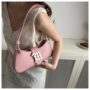 Detail of pink leather underarm bag featuring a vintage silver metal clasp and knotted strap