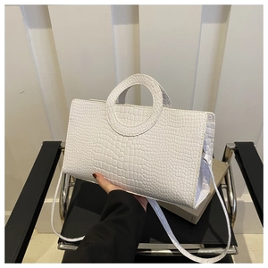 Detail of white crocodile pattern PU leather shoulder bag with circular hollow handle