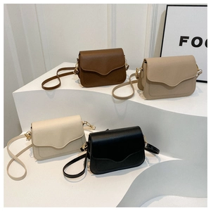 Minimalist square flap bags in brown, beige, cream, and black on geometric stands