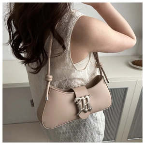 Detail of beige half-moon shoulder bag with silver buckle and adjustable knot strap