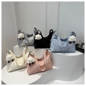 Group display of chic tote bags in five colors with cute cloud pendants on a white stand