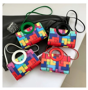 Detailed view of colorful Tetris-style block pattern bags with circular handles