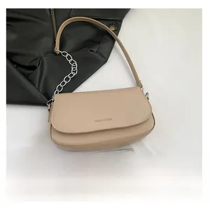 Detail view of cream saddle bag with fashion text and silver chain strap sizing