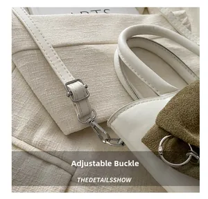 Détail de la bandoulière réglable en cuir avec boucle en métal argenté sur un sac