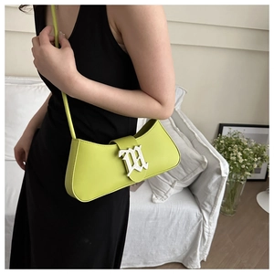 Detail of lime green faux leather shoulder bag with silver Gothic M buckle and strap