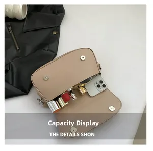 Internal view of beige chain shoulder bag showing capacity for phone and cosmetics