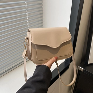 Beige faux leather crossbody bag with decorative stitching and gold hardware detail