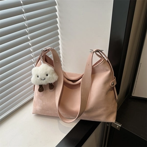 Light pink tote bag with soft texture and cloud charm in minimalist natural window light