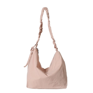 Pink nylon crossbody tote bag with trendy scrunchie strap and spacious interior