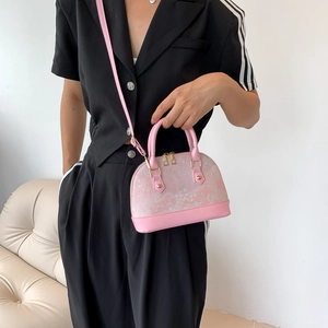 Pink jacquard shell bag with leather handles and adjustable strap for women