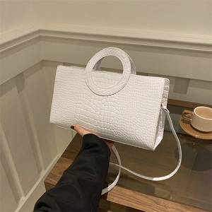 White faux crocodile leather handbag with round ring handle and long crossbody strap
