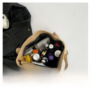 Top view of large straw tote bag showing spacious interior with daily essentials and black lining