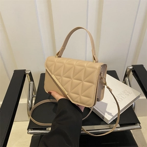 Chic beige quilted crossbody bag with top handle and triangular stitching texture