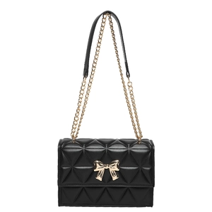 Quilted black chain bag with golden bow clasp and crossbody strap on white background