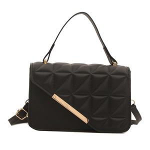 Elegant black quilted leather handbag with gold metal bar accent and top handle strap