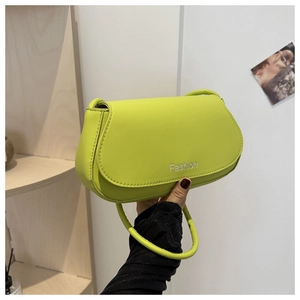 Detail of neon green leather handbag with silver Fashion print and round handle