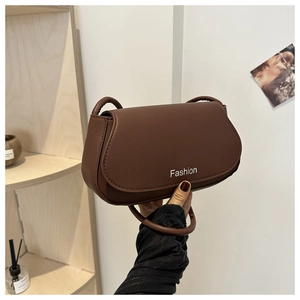 Detail of a brown matte leather half-moon shoulder bag with Fashion lettering