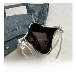 Interior view of large white woven tote bag showing space for phone and wallet